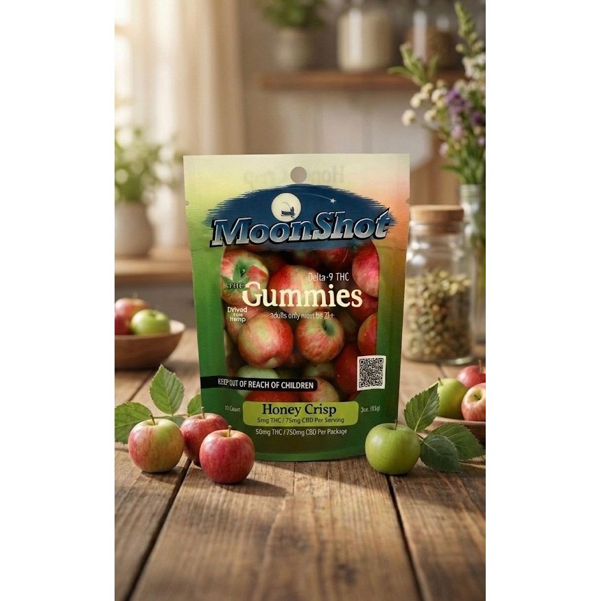 MoonShot Gummies package with honey crisp apples on a wooden table