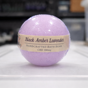 Purple bath bomb with a label on a white surface