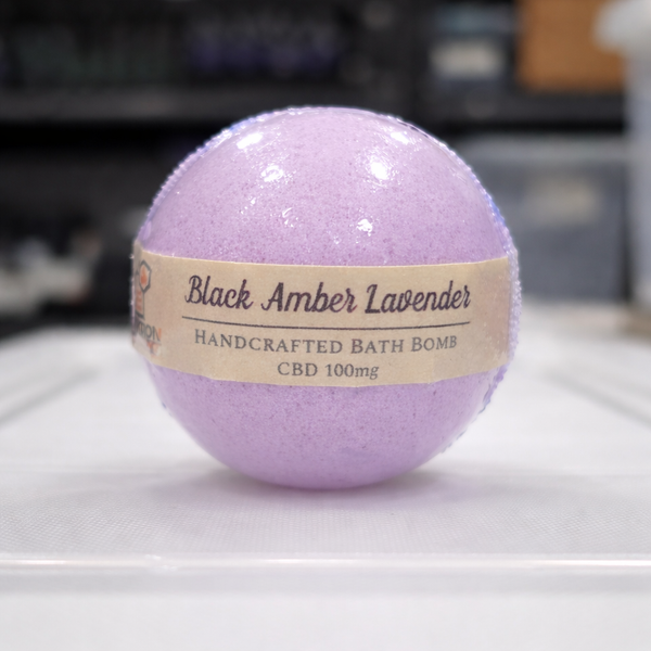 Purple bath bomb with a label on a white surface